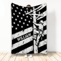 Black and white lineman blanket featuring a utility worker climbing a power pole beneath stars and stripes