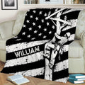 Custom lineman blanket draped over a couch with a utility worker climbing a pole in bold flag-inspired artwork