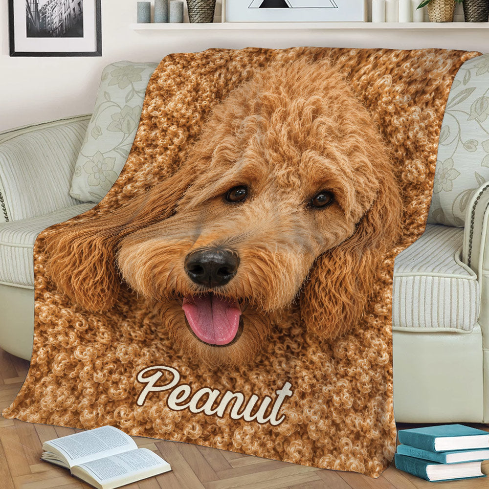 Goldendoodle throw blanket displayed on a couch with a close-up happy dog artwork