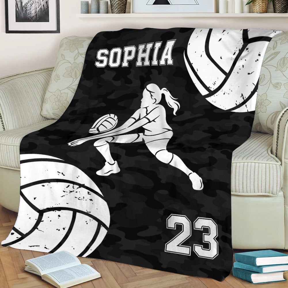 Volleyball couch blanket displaying a female player silhouette, large volleyballs, and monochrome sports artwork