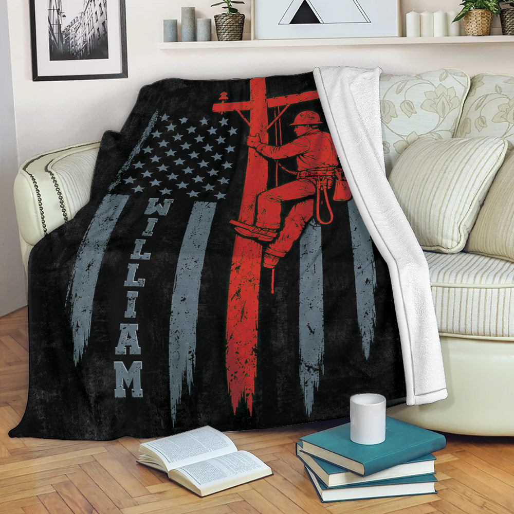 Patriotic lineman blanket draped over a sofa with a utility worker and flag-inspired design