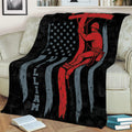 Lineman throw blanket displayed on a couch with bold red, black and gray utility worker artwork