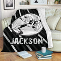 Wrestling throw blanket displayed on a sofa with dynamic grappling artwork and a bold striped border