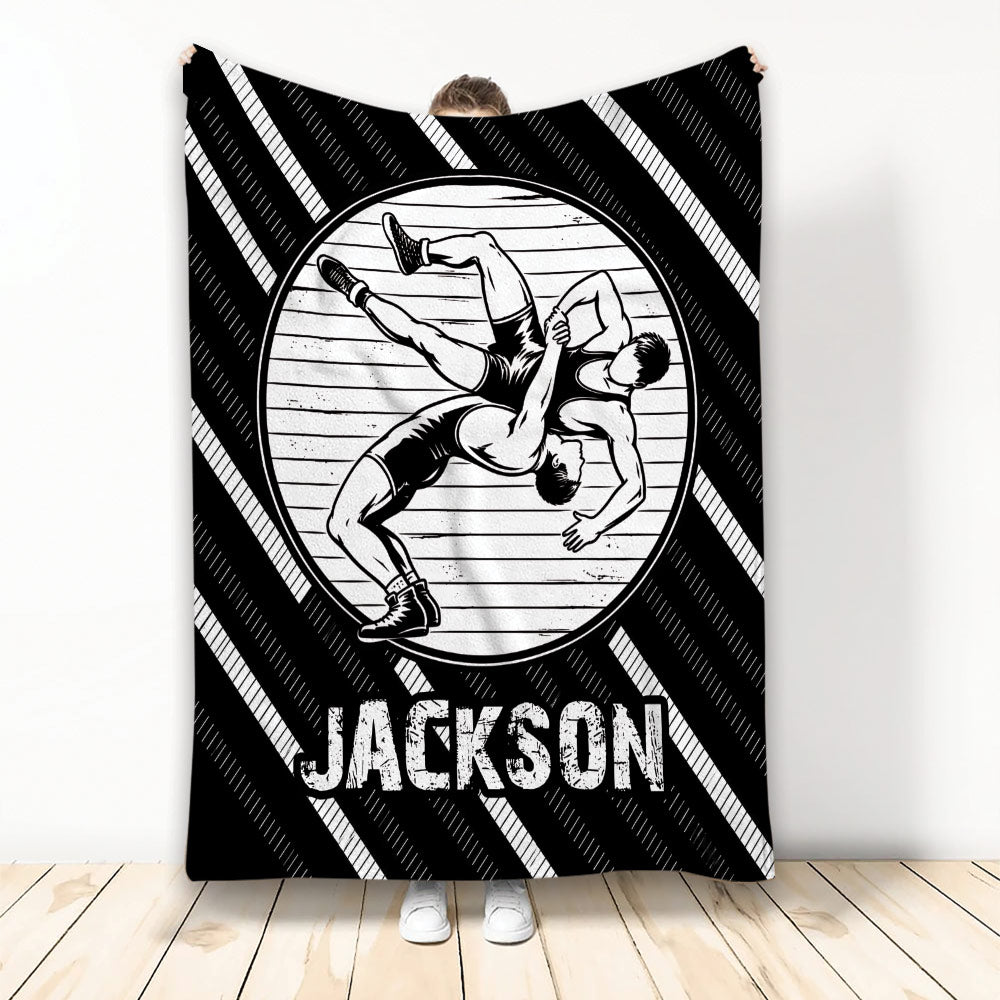 Custom wrestling throw blanket featuring two wrestlers grappling on a mat in bold black and white artwork