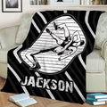 Black and white wrestling blanket draped over a couch with illustrated wrestlers in action
