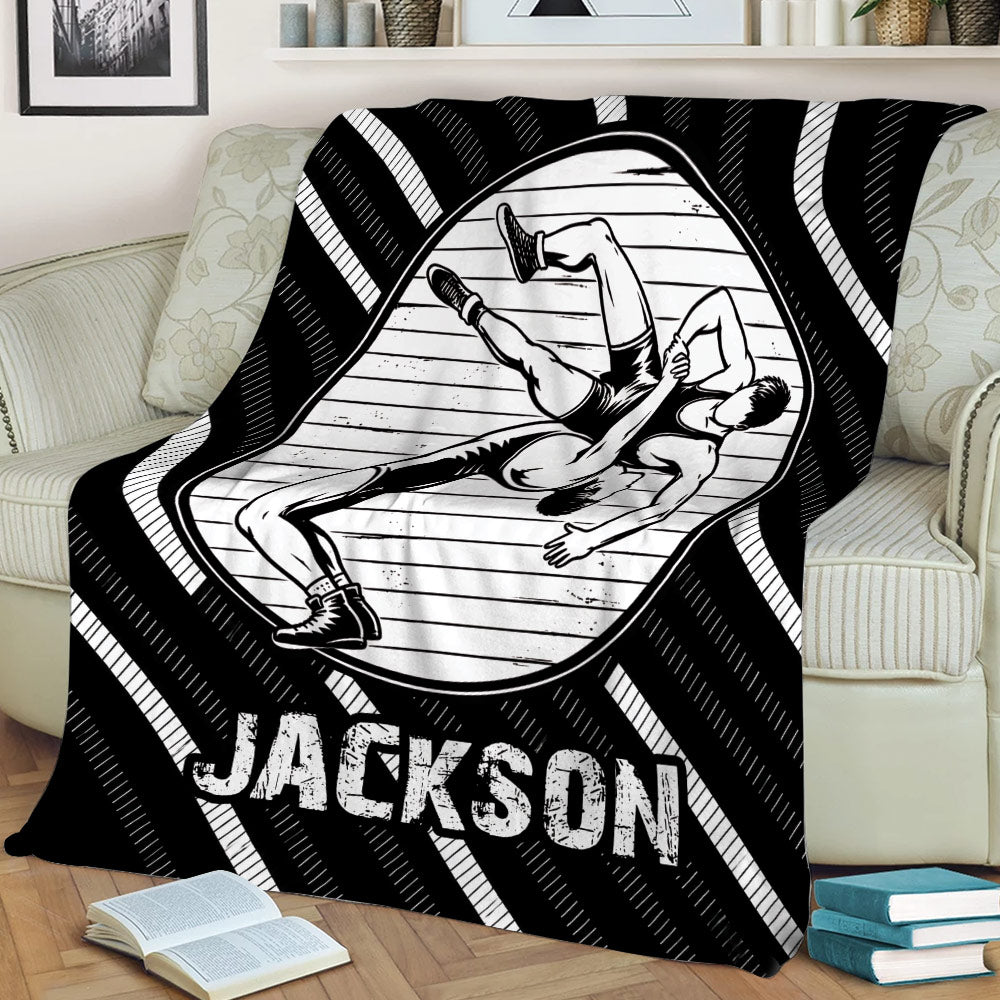 Black and white wrestling blanket draped over a couch with illustrated wrestlers in action