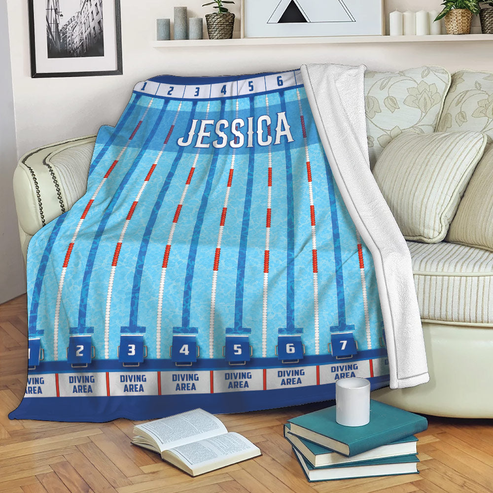 Swimming pool lane throw blanket draped over a sofa in a cozy living room