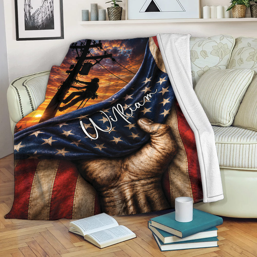 Patriotic lineman blanket draped over a sofa with power pole artwork and utility worker silhouette