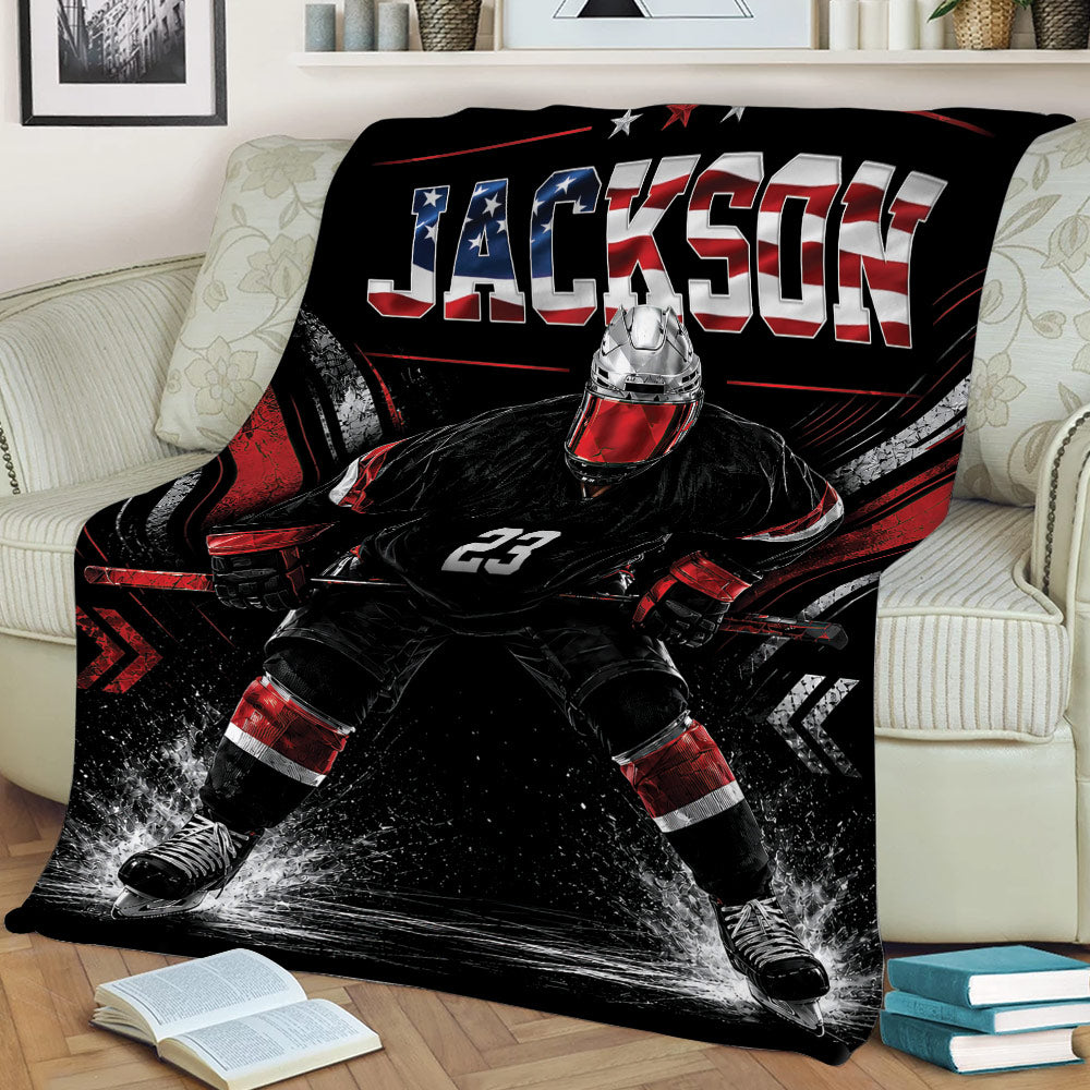 Close lifestyle view of a hockey blanket featuring a helmeted goalie and bold red, white and black graphics