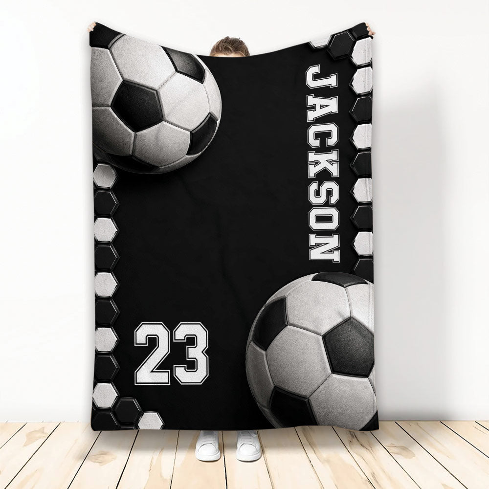 Black and white soccer ball artwork on a custom soccer blanket displayed in a room
