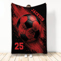 Red and black soccer throw blanket displayed vertically with bold ball artwork and splatter-style sports graphics
