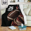 Football throw blanket draped over a sofa with oversized football artwork and patriotic colors