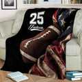 Football blanket styled on a couch with large football artwork, dark tones, and red star details