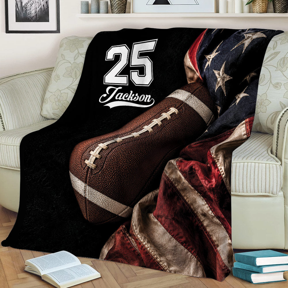 Football blanket styled on a couch with large football artwork, dark tones, and red star details