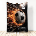 Custom soccer blanket featuring a dramatic soccer ball hitting the net with fiery orange effects