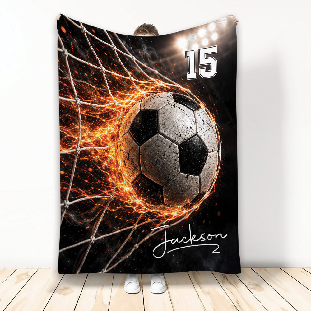 Custom soccer blanket featuring a dramatic soccer ball hitting the net with fiery orange effects