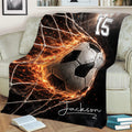 Soccer blanket draped over a couch with an action-style ball and goal net design