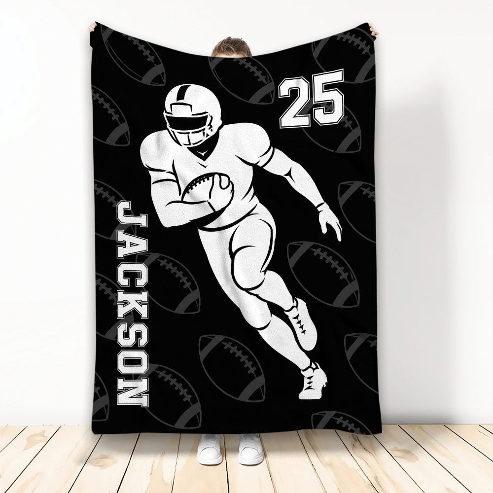 Black football blanket featuring a running player illustration and repeating football pattern