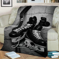 Ice hockey blanket draped over a sofa with dramatic black and white equipment artwork
