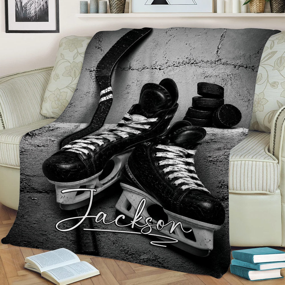 Ice hockey blanket draped over a sofa with dramatic black and white equipment artwork