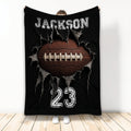 Black football blanket with dramatic ripped fabric artwork, white jersey-style graphics, and a large brown football