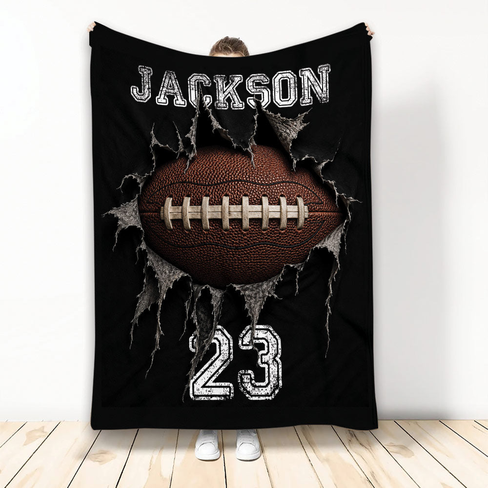 Black football blanket with dramatic ripped fabric artwork, white jersey-style graphics, and a large brown football