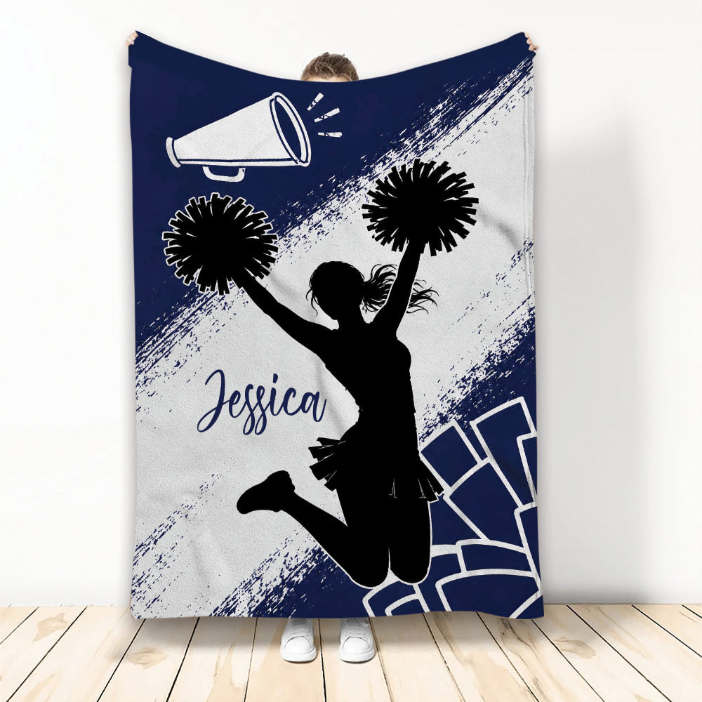 Cheerleading throw blanket with cheerleader silhouette, pom-poms, megaphone, and navy blue sports artwork