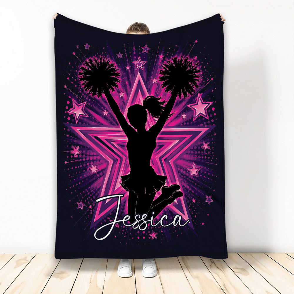 Cheerleading throw blanket with cheerleader silhouette, pom-poms, pink stars, and bold purple artwork