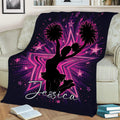 Cheerleading throw blanket draped over a couch, featuring pom-poms, stars, and colorful cheer artwork