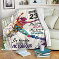 Colorful softball throw blanket displayed on a living room sofa