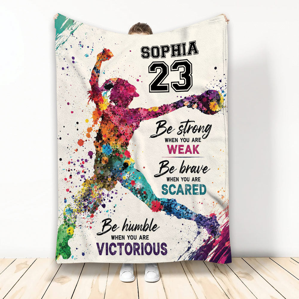 Colorful softball player artwork on a motivational custom throw blanket