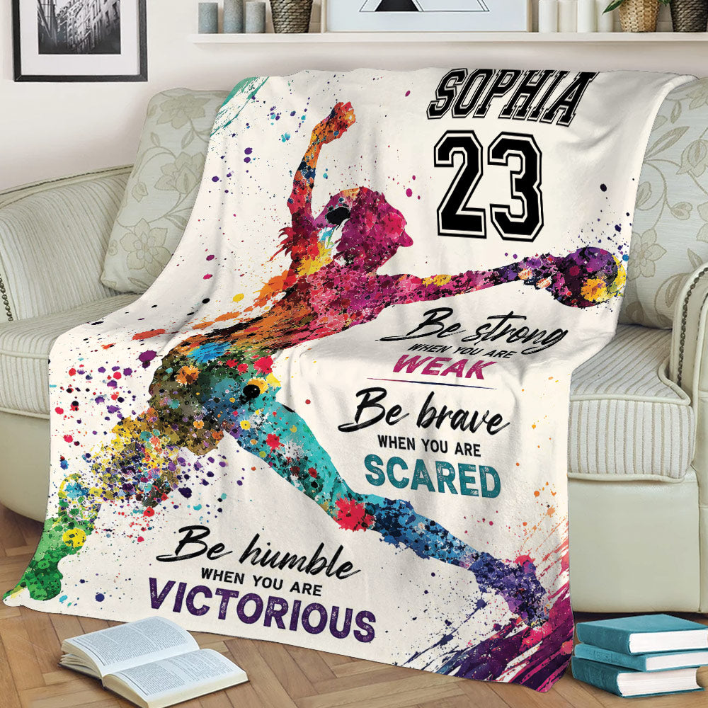 Softball player artwork and motivational typography on a couch blanket