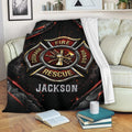 Firefighter blanket displayed on a sofa with bold red, black, and metallic artwork