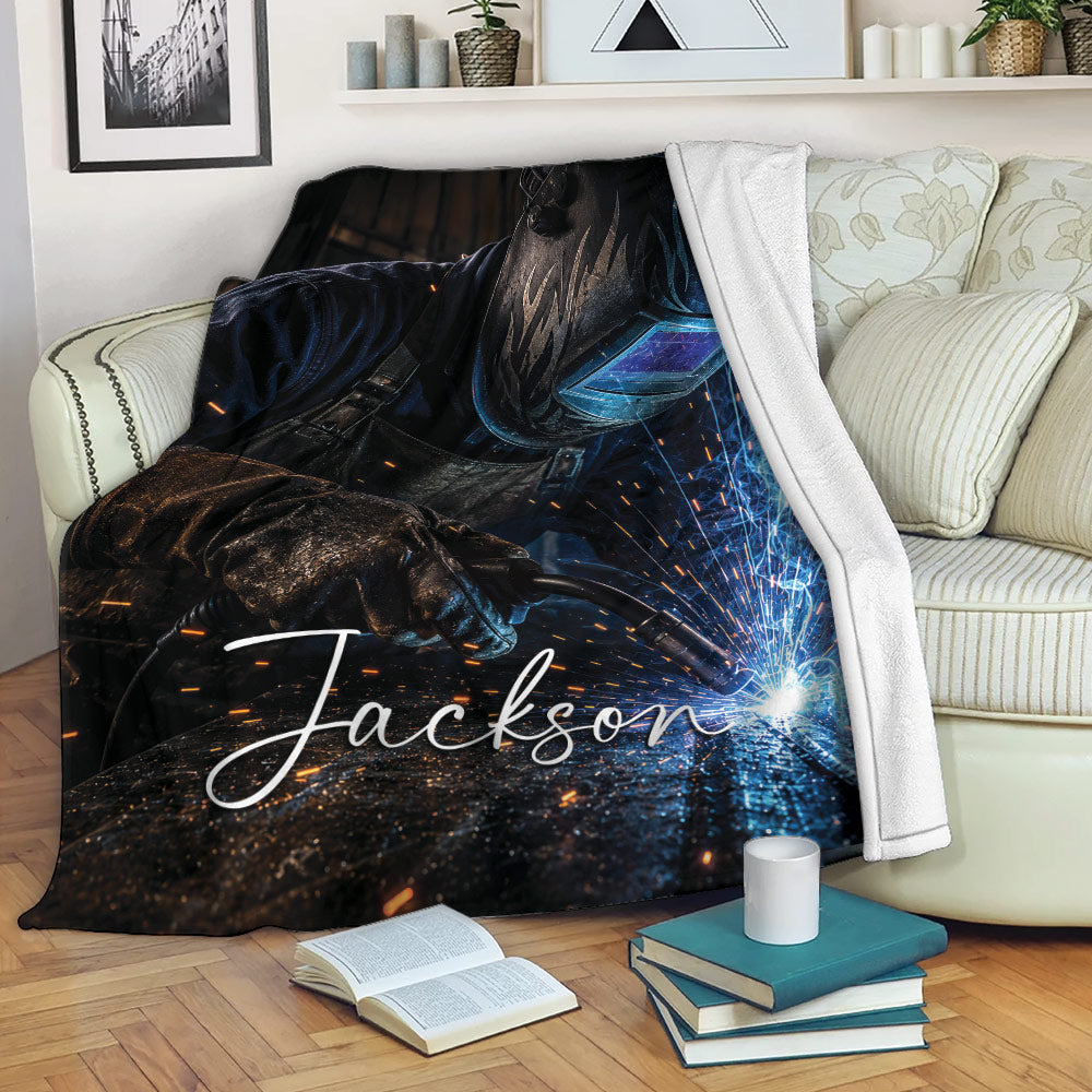 Welder blanket displayed on a sofa with welding sparks and industrial artwork