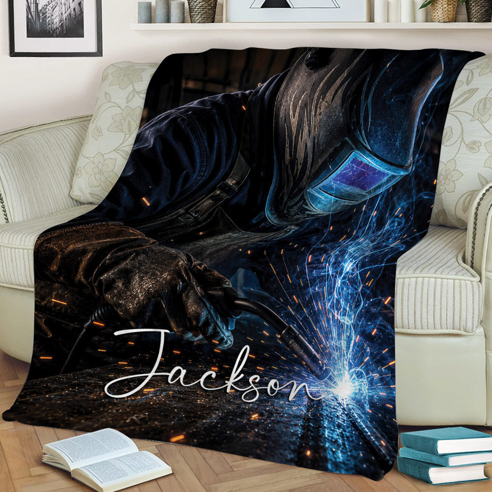 Welder throw blanket draped over a sofa, showing protective gear and vivid welding sparks