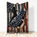 Softball throw blanket featuring a female batter silhouette over a distressed patriotic flag design