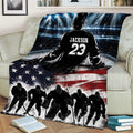 Hockey blanket draped across a couch with an ice rink scene, silhouetted players, and patriotic flag design