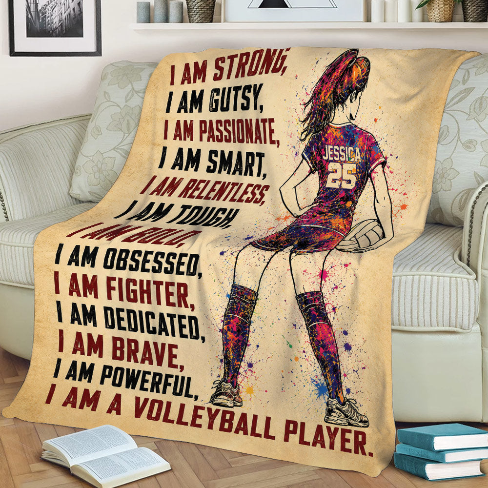 Volleyball blanket draped over a couch with colorful female player artwork and motivational athletic typography