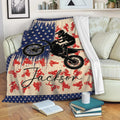 Motocross blanket draped over a sofa with dirt bike artwork, navy stars and red accents