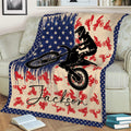 Motocross throw blanket displayed on a couch with a jumping dirt bike rider and star border