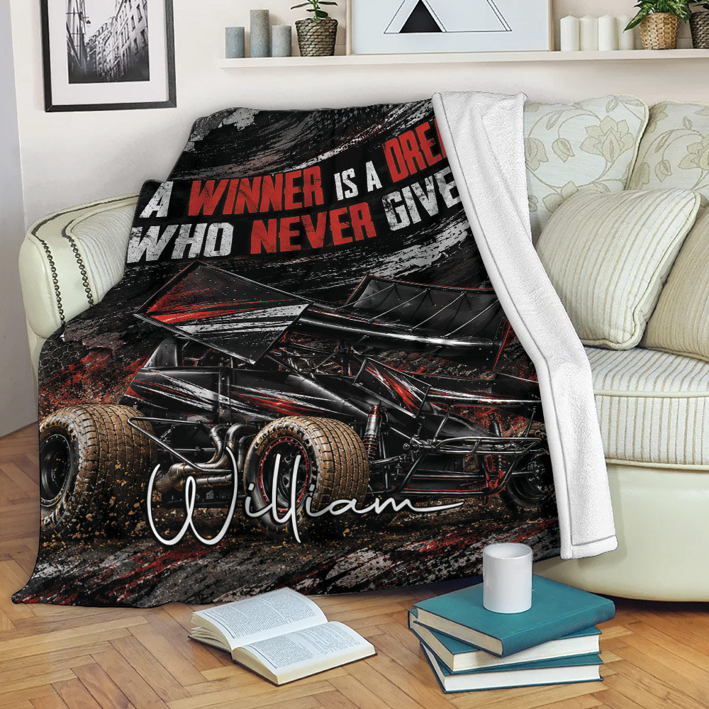 Dirt track racing throw blanket displayed on a sofa with bold sprint car artwork
