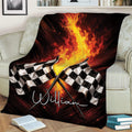 Checkered flag racing blanket with dramatic flames styled across a cozy living room couch