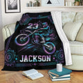 Motocross throw blanket displayed on a sofa with colorful dirt bike rider artwork