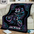 Motocross blanket draped over a sofa featuring dynamic dirt bike racing artwork