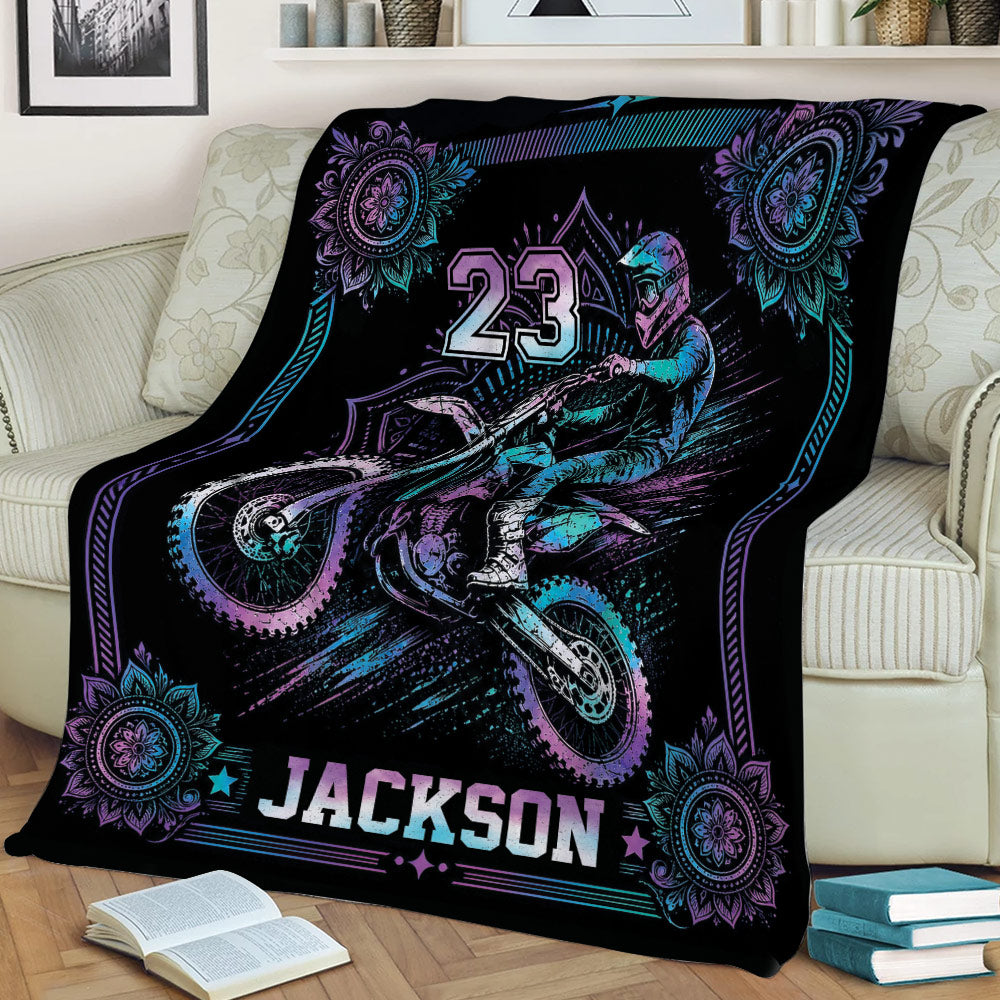Motocross blanket draped over a sofa featuring dynamic dirt bike racing artwork
