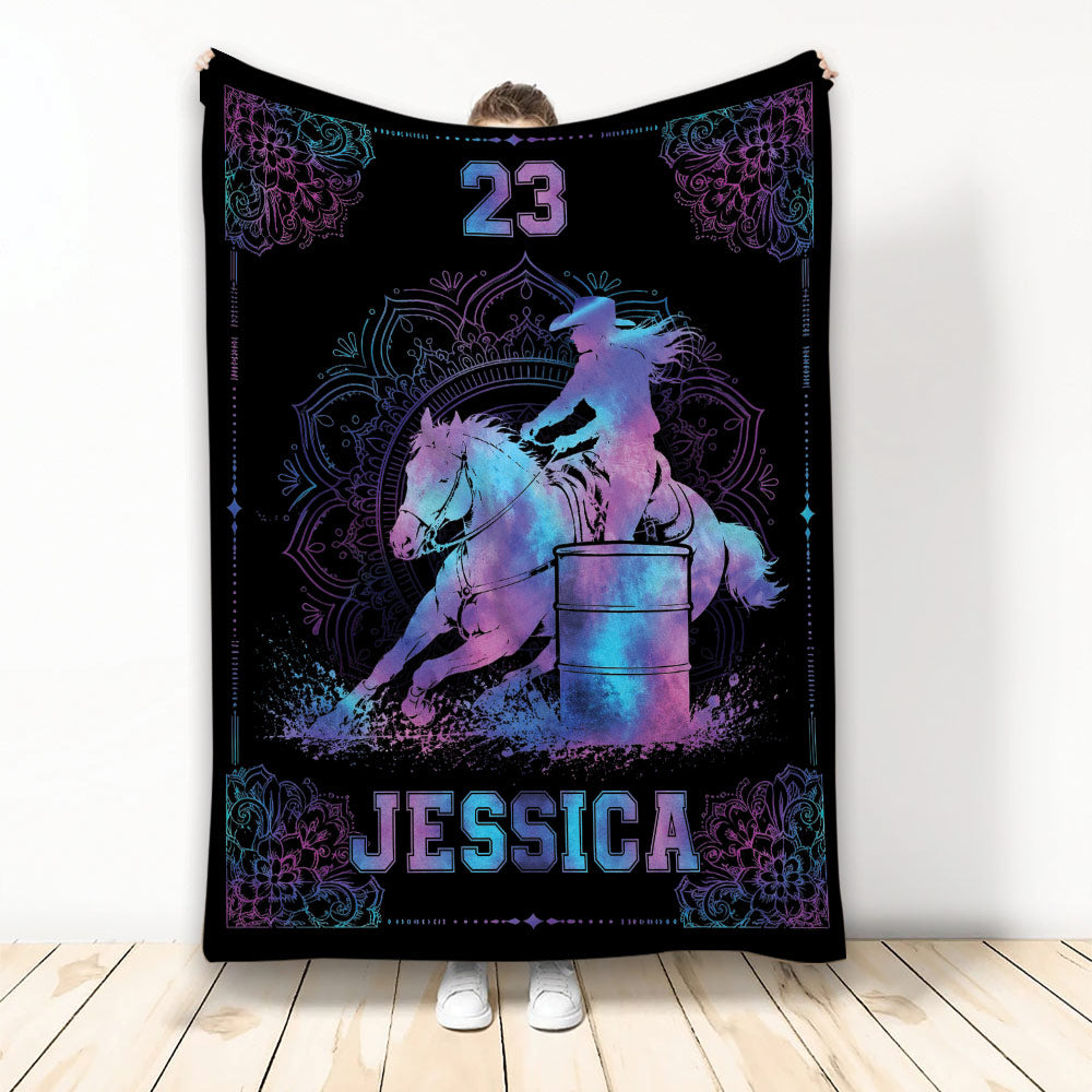 Barrel racing throw blanket with colorful horse and rider artwork, barrel, floral accents, and black background