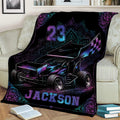 Dirt track racing blanket displayed on a sofa with bold sprint car artwork and colorful mandala details