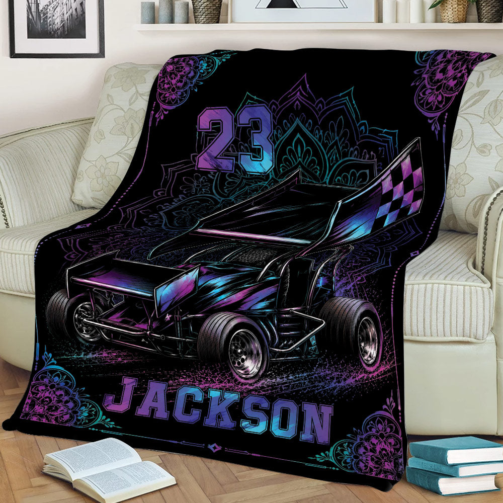 Dirt track racing blanket displayed on a sofa with bold sprint car artwork and colorful mandala details