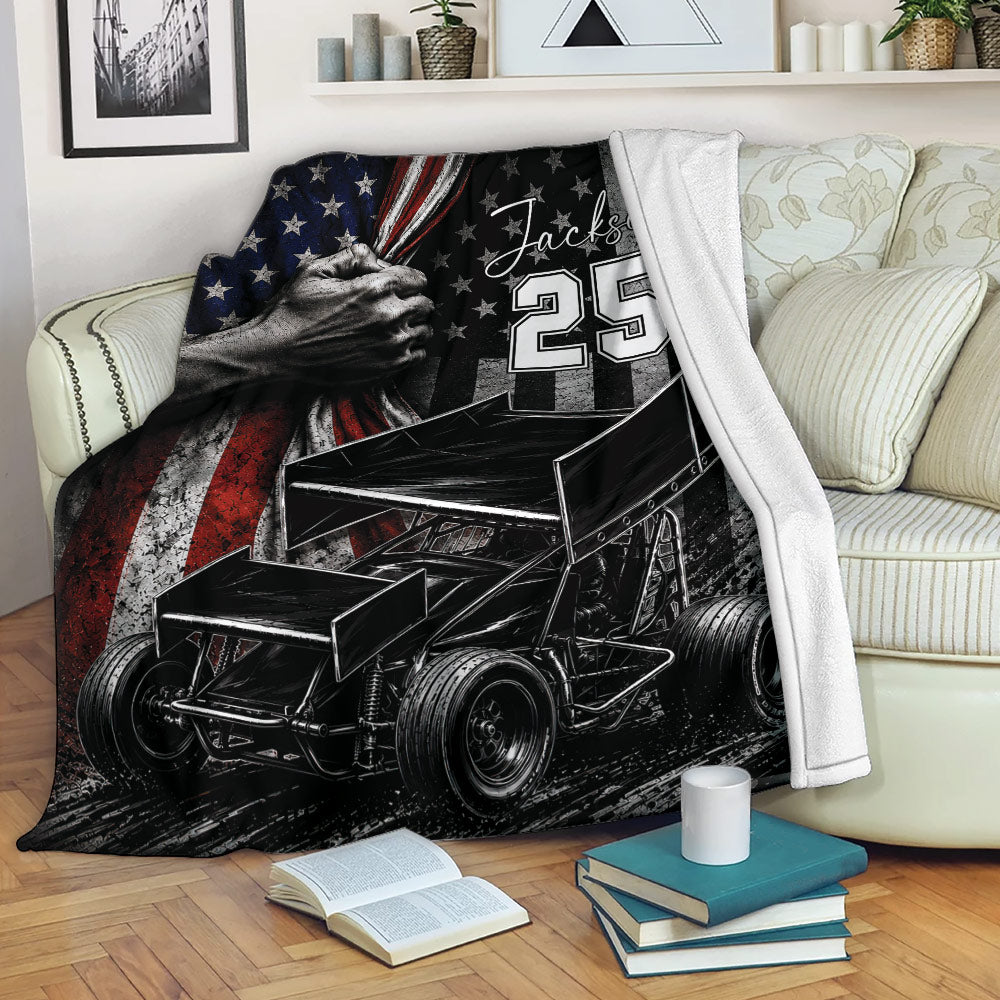 Dirt track racing blanket draped over a sofa with bold sprint car and patriotic artwork