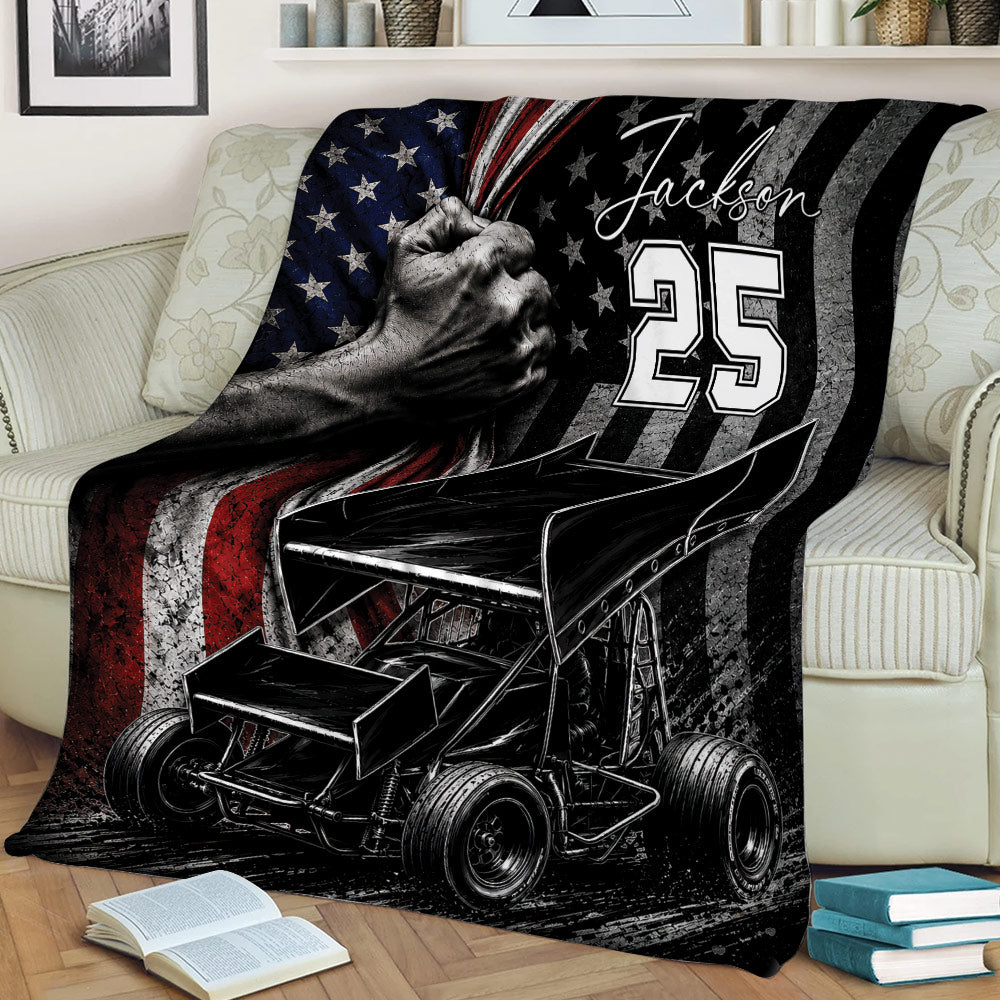 Sprint car dirt track racing blanket displayed on a sofa in a cozy living room